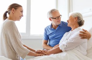 caregiver consoling senior woman